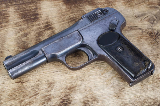 istock antique rusty handgun on wooden table 2066866292