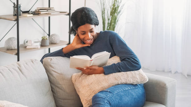 istock Book leisure smiling woman reading couch home 2066866869