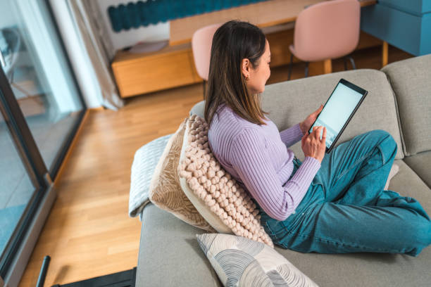 istock Serene Mature Asian Woman Using Tablet at Home 2066872984