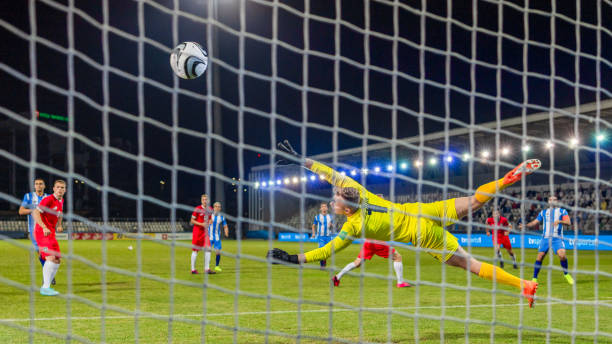 istock Soccer Player Scoring Goal During Nighttime Match 2066875222