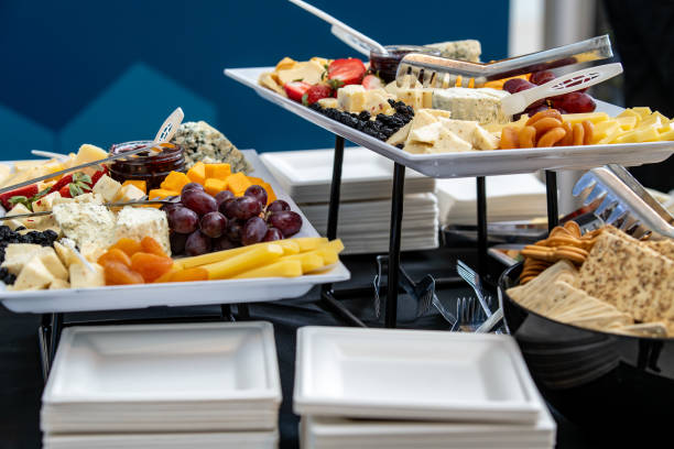A tray of cheese and crackers and fruit on display catered for snacks