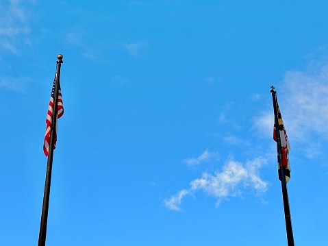 low angle view of the us flag on a pole with a white background
