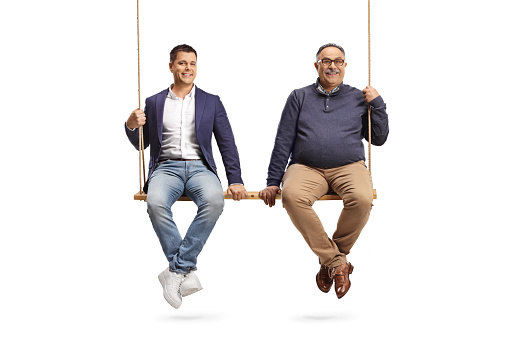 Casual man and a mature man sitting together on a big wooden swing isolated on white background