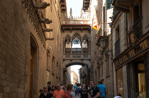 Barcelona, Spain- 10/12/2023: The Pont de Bisbe is seen amongst gargoyles in Barcelona's Gothic Quarter.
