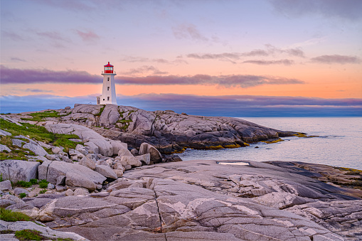 Sunrise colors behind Peggy's Cove Lighthouse.