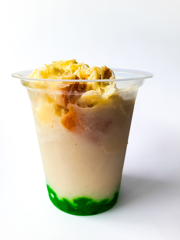 Durian Cendol Ice Drink in plastic glass packaging with a white background as an isolated background, this drink made from Durian fruit is one of the traditional drinks from Indonesia. This photo is suitable for something with a drink and culinary theme