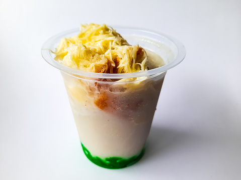 Durian Cendol Ice Drink in plastic glass packaging with a white background as an isolated background, this drink made from Durian fruit is one of the traditional drinks from Indonesia. This photo is suitable for something with a drink and culinary theme