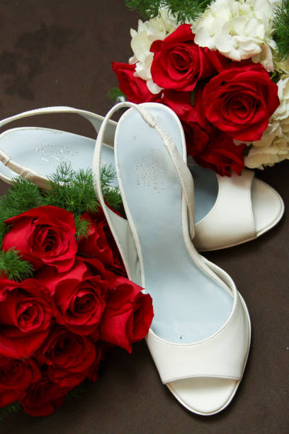 istock Red roses and bridal shoes 2067214088