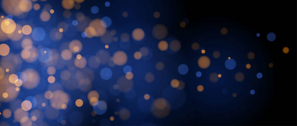 istock Blurred gold bokeh on blue background. Golden blurred effect wallpaper. Abstract shiny glitter, sparks, dust, sparkles. Glowing navy backdrop for Christmas, New Year or birthday card, banner. Vector 2067214610