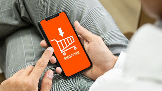online shopping concept.Smart phone online shopping in man hand. shopping online, buy in online shop by mobile smart phone app, Businessman phone and laptop using