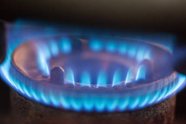 Steel Pot on the gas stove with burning flame in the kitchen.Soft focus.Close up.