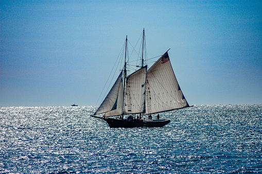 Saint-Tropez, FRANCE – September 27, 2010:  Sailboats in the race on sea against a blue sky. Every year in the last weekend of September, the week-long 'Voiles de Saint Tropez' starts. There are daily regattas in the Gulf of Saint Tropez between classic and contemporary sailing ships. Picturesque Saint Tropez on the French Riviera in southern France provides the backdrop for the competitions that attract many visitors every year.