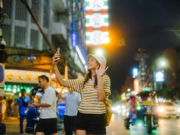 istock Woman talking on video call exploring Chinatown in Bangkok 2067413336