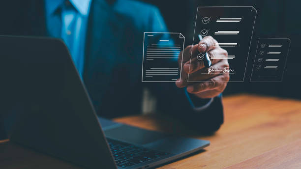 istock Businessman is Signing and electronic signature concept Managing electronic documents in a paperless workplace Scanning digital documents on a virtual laptop screen using a stylus pen. 2067426985
