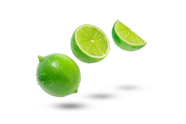 istock Flying green lime with slices and shadow isolated. 2067447843