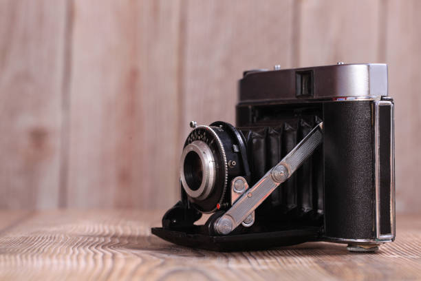 Retro camera on a wooden table, close-up