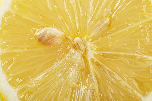 Close up of delicious lemon showing pulp and seeds with copy space