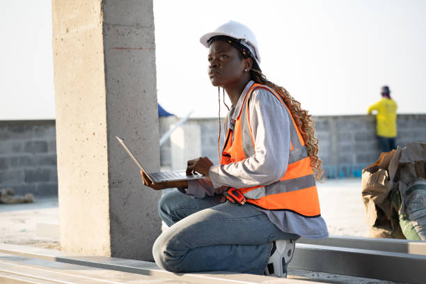 istock Portrait very tired worker African woman with holding notebook computer at construction site 2067508681