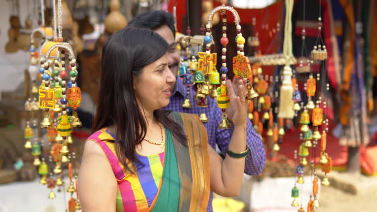 Happy couple buying souvenir at carnival