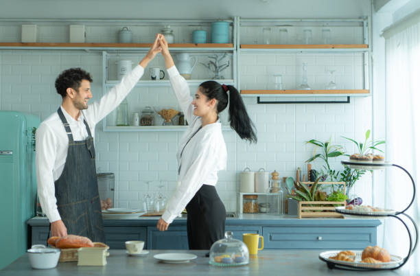istock A husband wears an apron while cooking dinner with his wife. He was dancing happily before entering the kitchen to cook. 2067549383
