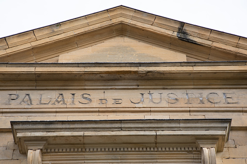 palais de justice text on entrance ancient wall facade building means in french courthouse justice court