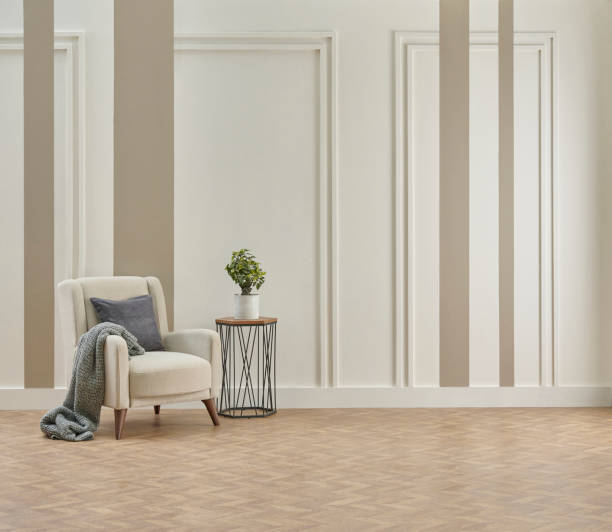 istock Decorative white and brown vertical wall background, home design, sofa working table, red chair, vase of plant, book accessory, lamp, middle table on the modern wood parquet. 2067564347