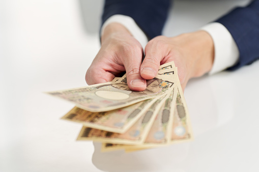 Hand of businessman paying money