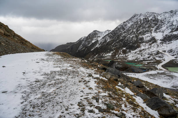 istock High rocky mountains with a valley, lakes and some snow. 2067604954