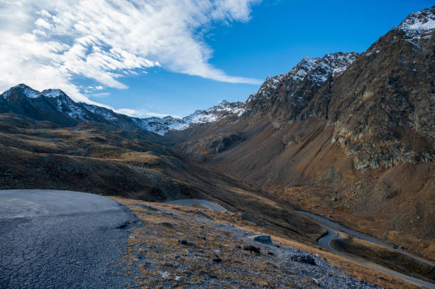 Mountain asphalt road high in rocky mountains.