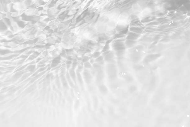 istock White water surface texture with ripples, splashes, and bubbles. Abstract summer banner background Water waves in sunlight with copy space cosmetic moisturizer micellar toner emulsion. White water. 2067637732