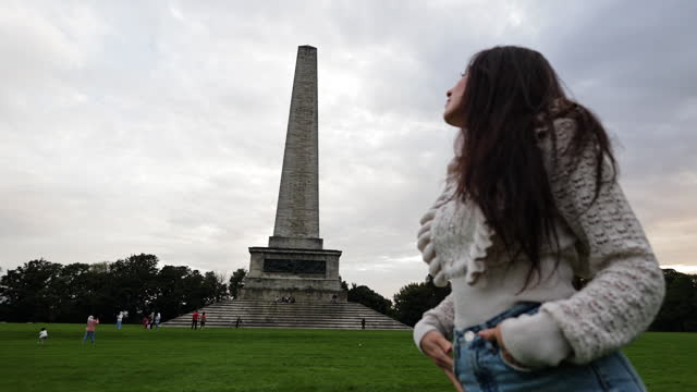 The only young woman watching around, solotravel discovers new places, Wellington Monument, Wellington Monument in Phoenix Park in Dublin Ireland, famous tourist attraction in Ireland, landscaped park in Europe, famous city parks in Europe