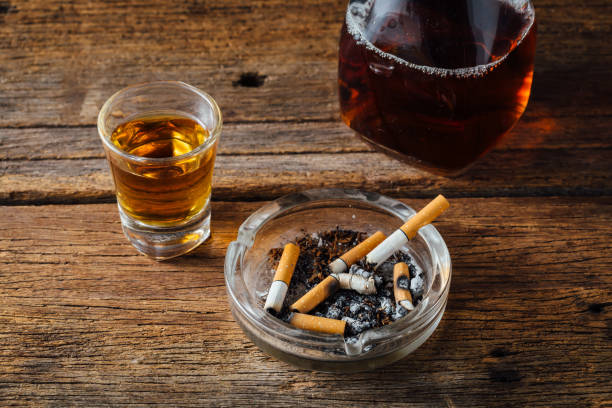 istock Whiskey and cigarettes with ashtray on wooden background 2067645664