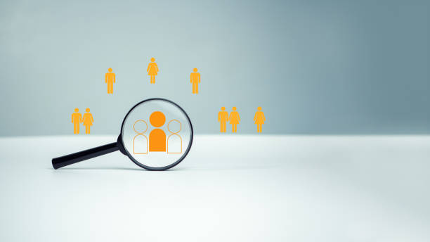 istock Customer group icons in a magnifying glass placed on a white background represent the selection of business goals, target customers, Marketing plans and strategies, customer-centric strategies. 2067660154
