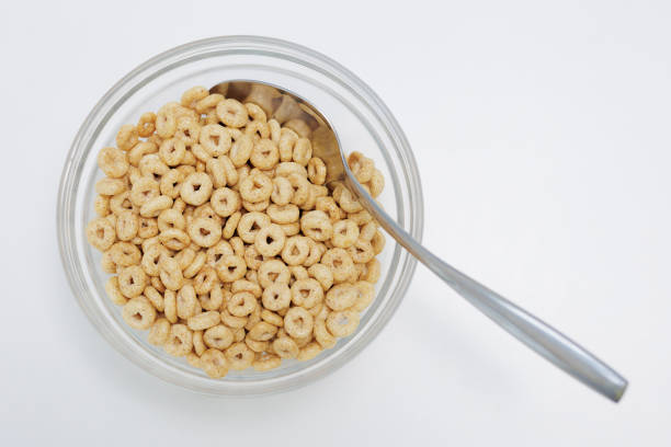 istock Loops cereals served in glass bowl with spoon on white background 2067661203