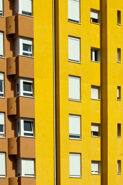 Low angle view of multi colored residential apartment buildings facades, vibrant yellow. Full frame view,  Galicia, Spain.