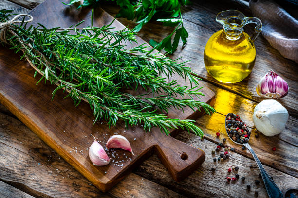 Fresh rosemary twigs on cutting board