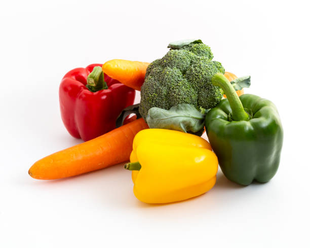Bell peppers, carrots and broccoli on white background