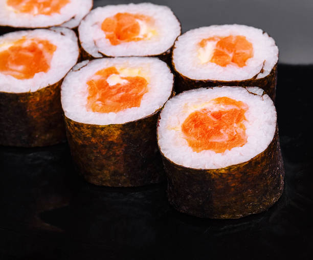 istock Salmon Maki Sushi on Black Stone Plate 2067688113