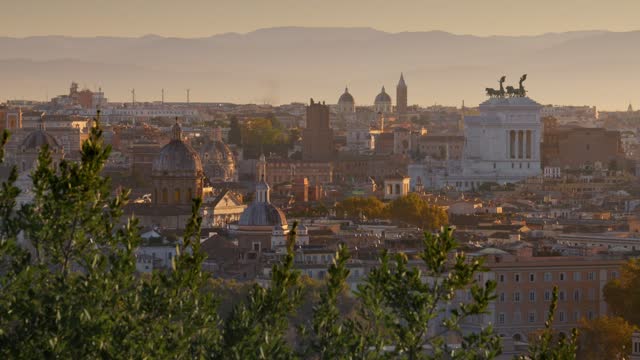 Beautiful Rome in morning lights of sun. Panning shot from Belvedere del Gianicolo. Churches and old town of Rome at sunrise, Italy