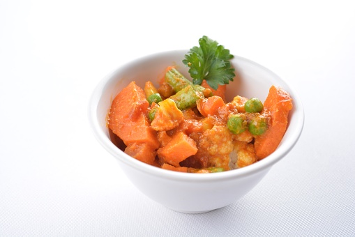 Indian mixed vegetable bean curry sauce nuts vegan dim sum in bowl on white background asian chef appetiser halal bakery food restaurant pastry menu for cafe