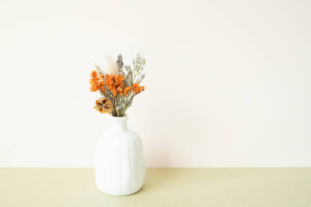 istock White vase of dry flower on table. white ivory background 2067701218