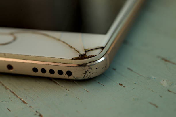 Close up of broken smartphone isolated on the wood