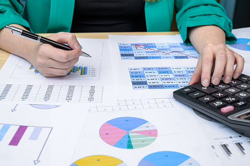 An accountant at work analyzes financial data and calculates the profitability of investments
