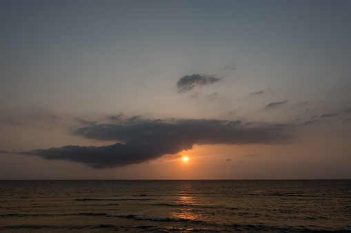 warm sunrise with a dark cloud at the red sea in egypt