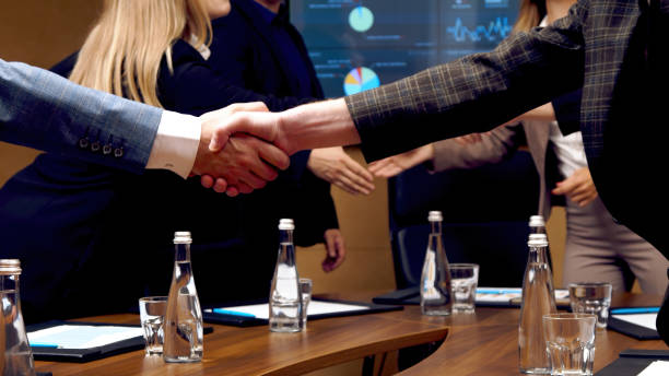 istock In the conference room, a team of CEOs are meeting, talking, finalizing the development, and shaking hands. Stylish people in a modern conference room. 2067738412
