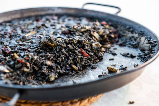 istock Typical Spanish black paella at an event in a restaurant, with squid ink 2067745835
