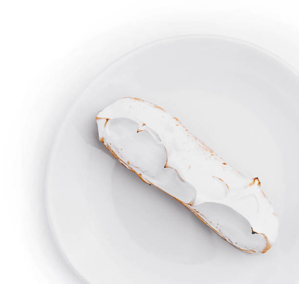 istock eclair with meringue on white plate top view 2067756692
