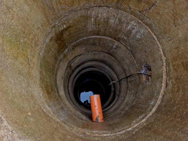 istock a deep well drilled from concrete pipe fittings. teaching how to install a pump under water with high pressure for watering flower beds. circle 2067768026