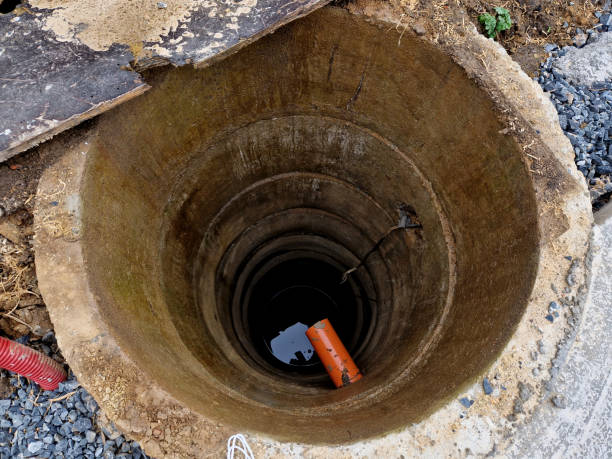 istock a deep well drilled from concrete pipe fittings. teaching how to install a pump under water with high pressure for watering flower beds. circle 2067768557