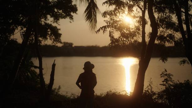 In silhouette solo traveling in nature.